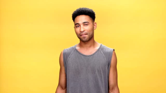 Young-shocked-african-man-over-yellow-background.