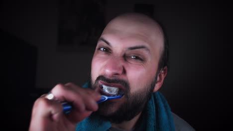 4K-Man-Looking-in-Mirror-and-Brushing-Teeth