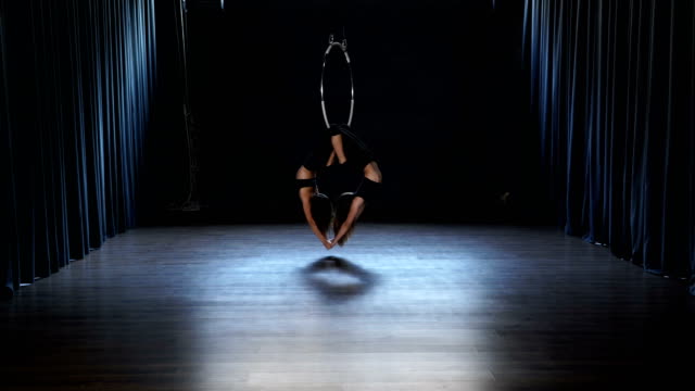 Charming-acrobats-performs-a-trick-in-the-aerial-hoop