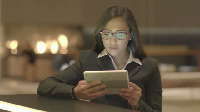 Young-Attractive-Black-Women-Using-Tablet-Computer-Searching-the-Web-Online.-African-American-Female-in-Business-Suit-Connecting-with-Social-Media.-Urban-Lifestyle-Background