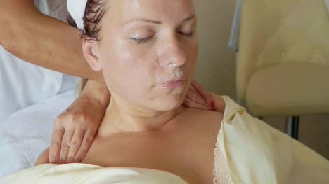 Attractive-female-at-spa-health-club-getting-a-facial-massage