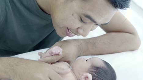 4K-Slow-motion-Happy-Asian-father-take-care-his-newborn-baby-daughter-at-home
