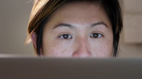 Close-up-of-Asian-woman-using-computer