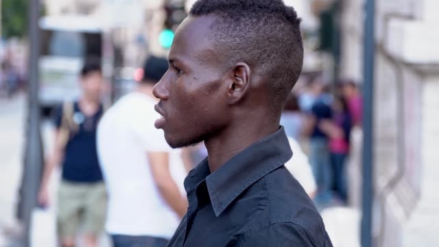 young-american-african-man-standing-in-the-street--profile--slow-motion