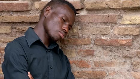 sad-thoughtful-lonely-american-african-man-leaning-on-the-wall