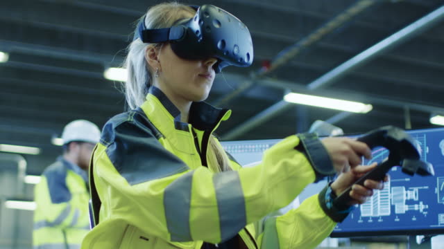 Factory:-Female-Industrial-Engineer-Wearing-Virtual-Reality-Headset-and-Holding-Controllers,-She-Uses-VR-technology-for-Industrial-Design,-Development-and-Prototyping-in-CAD-Software.