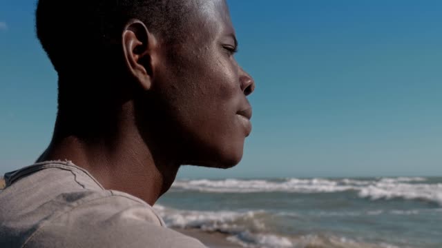 Migration,refugee,-Homeland.-Depressed-pensive-black-migrant-on-the-beach