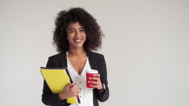 Happy-businesswoman-with-coffee-and-file
