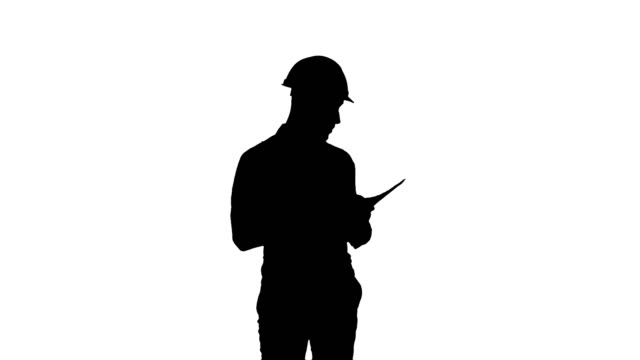 Silhouette-Young-engineer-in-helmet-checking-construction-plan