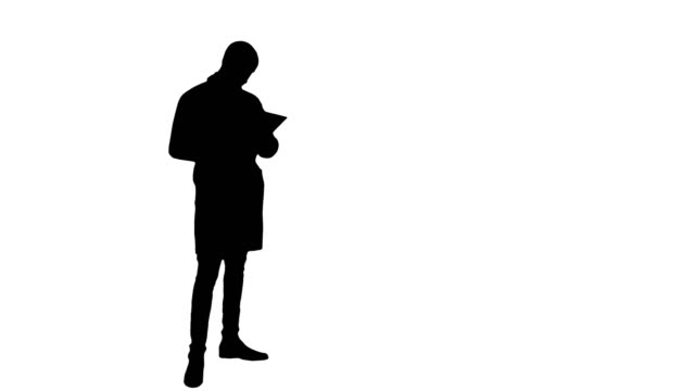 Silhouette-Young-male-doctor-using-digital-tablet