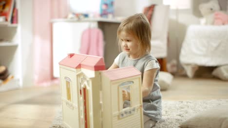 Happy-Little-Girl-Runs-Toward-Doll-House-und-Starts-Playing-with-It.