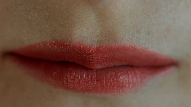 Extreme-close-up-of-lips-blowing-a-kiss-and-smiling