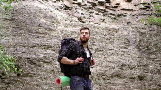 Close-up-of-male-hiker-with-backpack-in-mountains.