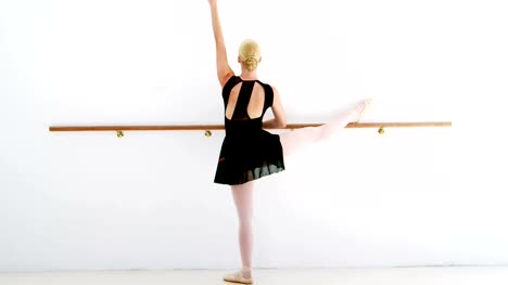 Ballerina-practicing-ballet-dance-at-barre