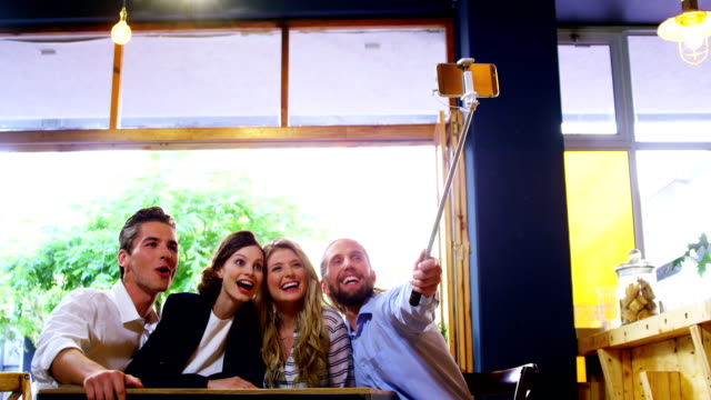 Friends-taking-a-selfie-in-café