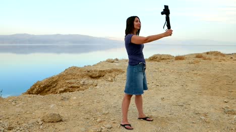 Brunette-longhair-woman-takes-selfie-in-mountains