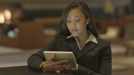 Young-Attractive-Black-Women-Using-Tablet-Computer-Searching-the-Web-Online.-African-American-Female-in-Business-Suit-Connecting-with-Social-Media.-Urban-Lifestyle-Background