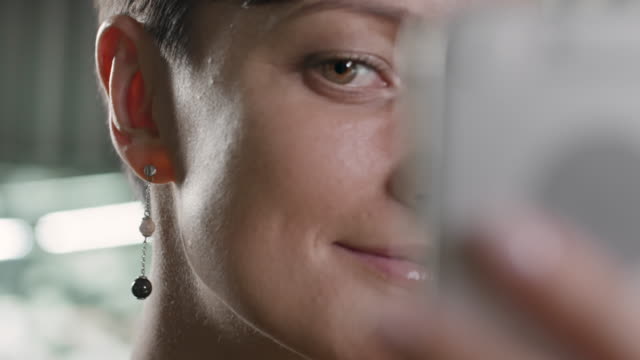Woman-Taking-Photo-in-Gemstone-Earrings