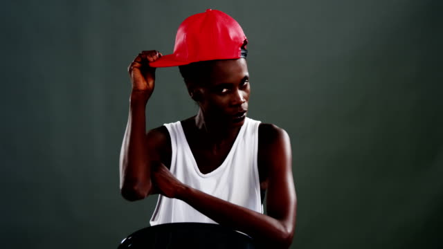 Androgynous-man-posing-with-red-cap