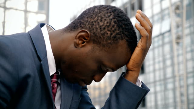 Thoughtful-and-worried-black-business-man-thinking-outdoor