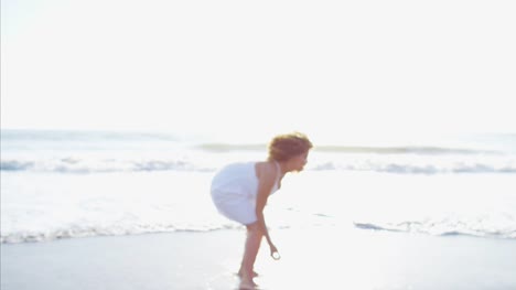 Portrait-of-Ethnic-female-running-barefoot-on-beach