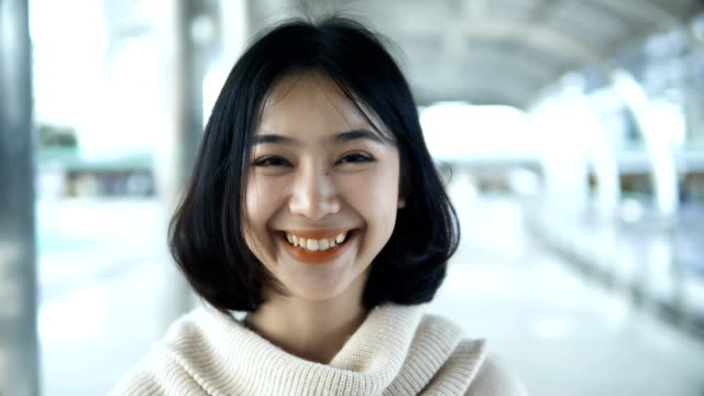 Portrait-Asian-pretty-teenager-looking-at-the-camera-and-smiling