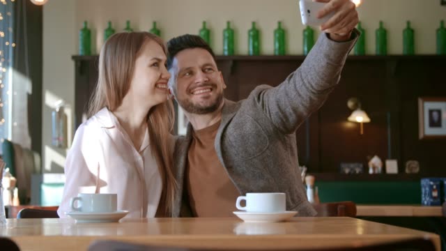 Happy-Couple-Taking-Selfie-on-Date