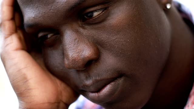 Close-up-on-pensive-daydreaming-young-black-african-man