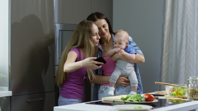 Lesbian-Couple-with-Baby-Taking-Selfie