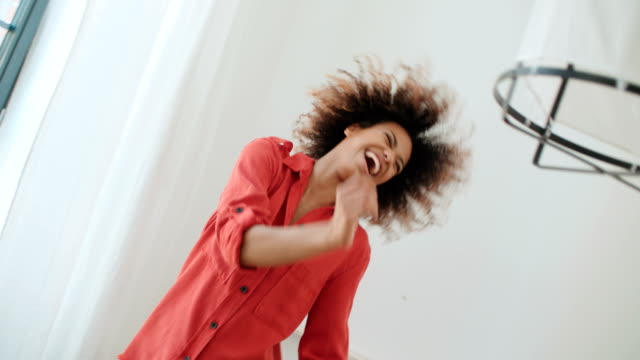 Portrait-of-happy-cheerful-young-afro-american-woman-at-home.