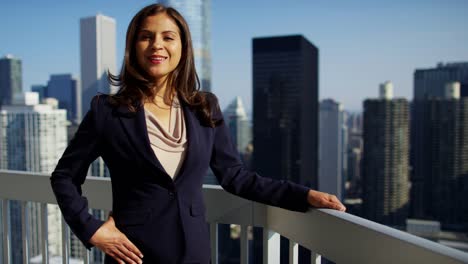 Portrait-of-Hispanic-businesswoman-on-city-skyscraper-rooftop