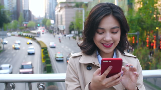 Young-woman-using-smartphone-in-the-city