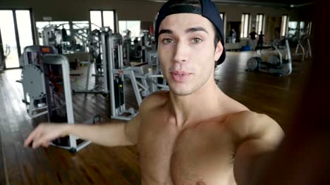 A-boy-during-a-break-from-training-takes-a-picture-in-the-gym-to-send-to-friends-or-girlfriend-or-to-post-on-social-networks.
