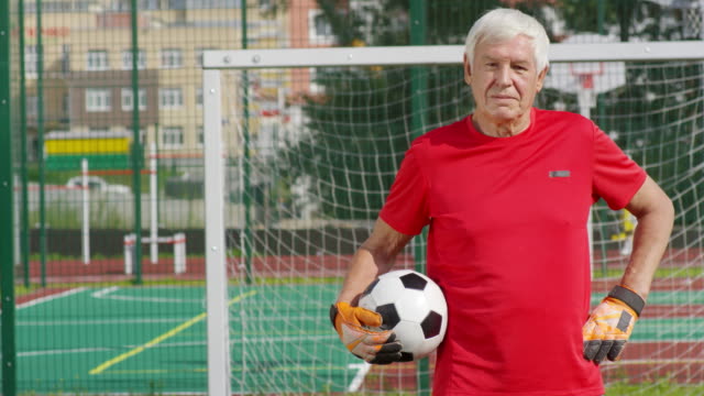 Portrait-of-Retired-Goalkeeper-at-Goal-Net