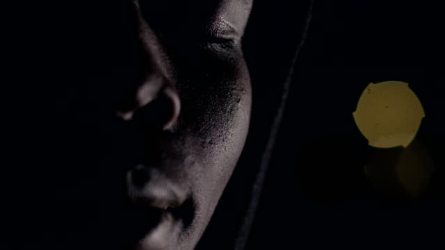 Depressed-thoughtful-african-man-in-the-darkness-opening-his-eyes