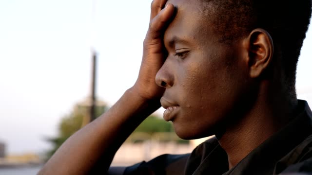 Worried-pensive-black-african-man-outdoor--profile