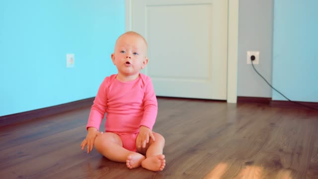 Beautiful-baby-sitting-at-home-on-the-floor