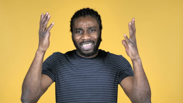 Casual-African-Man-Gesturing-Failure-and-Problems-Isolated-on-Yellow-Background