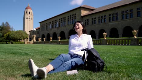 woman-sitting-on-the-grass-and-chilling-out-joyfully