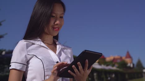 successful-businesswoman-wearing-in-elegant-shirt-with-gadget-outdoors