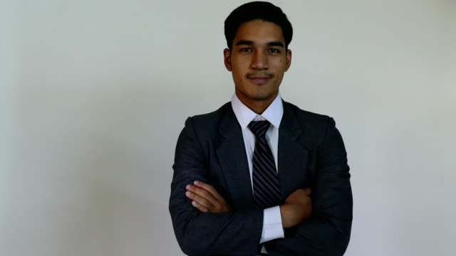 Lächelnder-junger-Mann-Start-up-Unternehmer-Unternehmer-trägt-grauen-Anzug-zeigt-seinen-Finger-auf-Sie-mit-weißem-Hintergrund