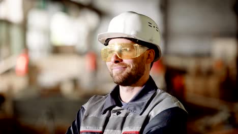 Portrait-of-an-adult-construction-worker-in-a-protective-helmet,-a-person-enjoys-the-process-of-building-high-quality-construction-of-his-subordinates