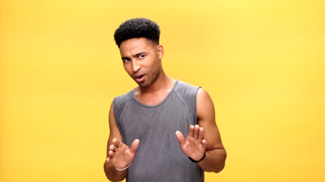 Young-angry-african-man-talking-over-yellow-background.