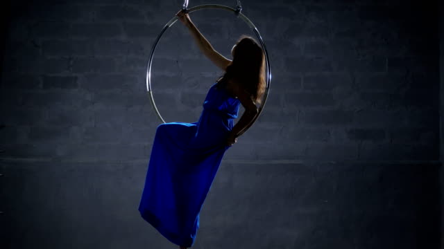 Beautiful-girl-in-long-blue-dress-in-the-aerial-hoop