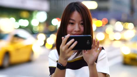 Handsome-Chinese-Woman-Texting-and-Talking-to-the-Phone-in-the-City.-Being-Happy,-Smiling-and-Having-Fun.