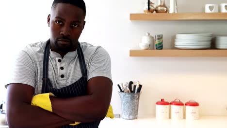 Confident-man-standing-with-arms-crossed-in-kitchen