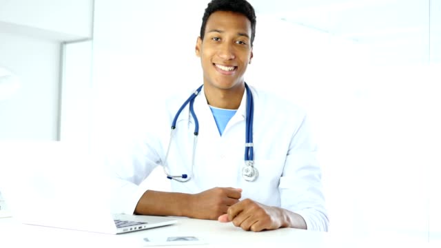 Afro-American-Smiling-Positive-Doctor-in-Clinic-Looking-at-Camera