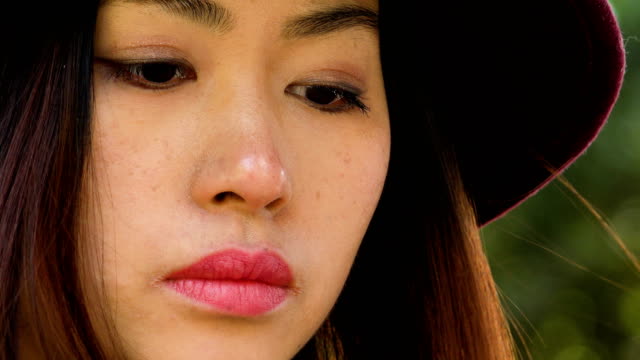 pensive-lonely-sophisticated-asian-woman-thinking,-close-up