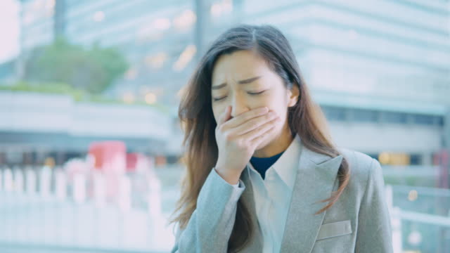 business-woman-coughing-and-sneezing-at-outdoor-in-the-city