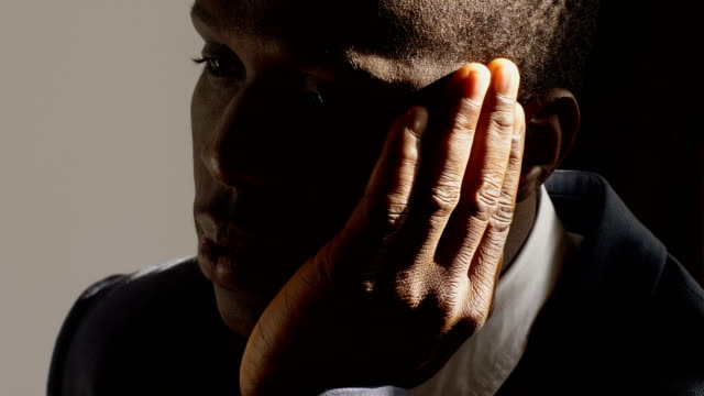 depressed-and-sad-black-business-man-in-the-dark--close-up